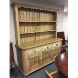 A Victorian style pine kitchen dresser fitted with three drawers