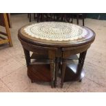 A circular mahogany coffee table fitted four beneath