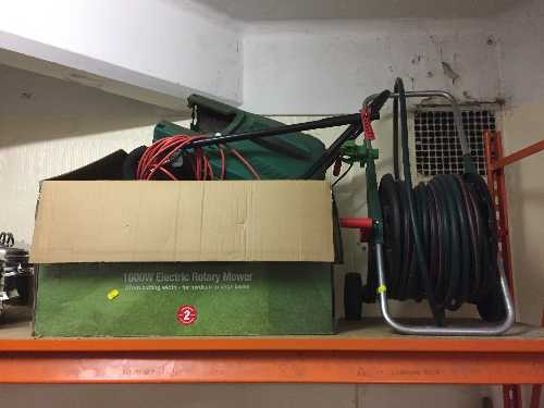 A Qualcast electric mower with box and lead,