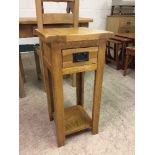 An oak side table fitted a drawer