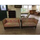 A pair of oak framed window seats in a floral fabric