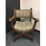 An early 20th century carved oak X frame chair