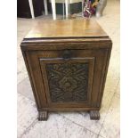 An Edwardian carved oak coal receiver with liner and shovel