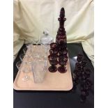 A tray of ruby glass decanter with glasses, glass lidded bon bon dish,