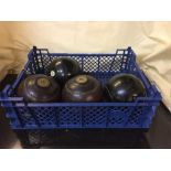 A crate of two pairs of vintage wooden bowling balls