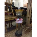 An early 20th century brass and glass oil lamp with shade and chimney