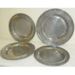 Four large antique pewter chargers of circular form with impressed marks &/or initials, 16½",