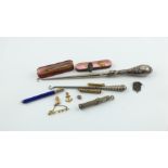 Two button hooks with silver handles; various propelling pencils & other items, some gold.