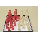 19th century Chinese carved ivory natural & red stained chess set, the kings each 3½" high.