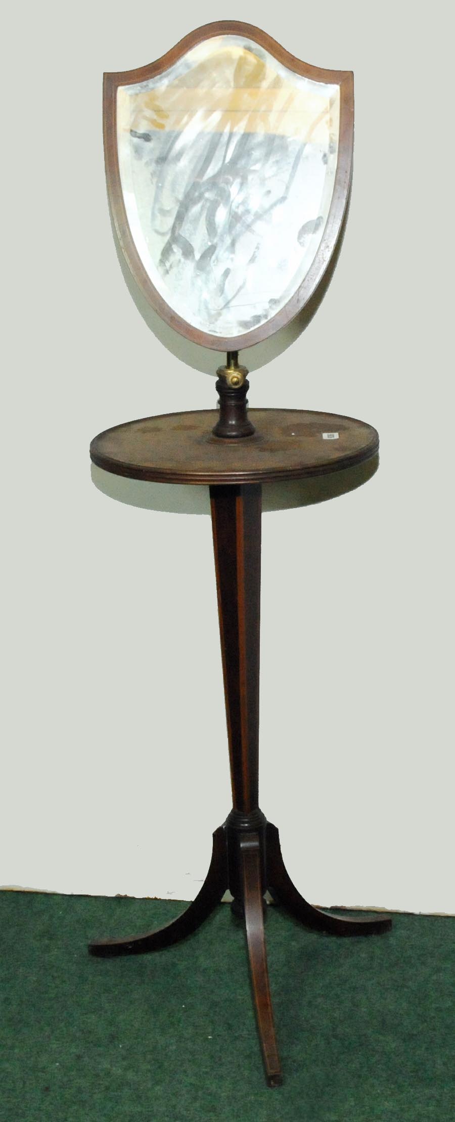 Late 19th century mahogany shaving table with shield shape adjustable mirror above circular top on
