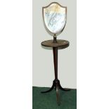 Late 19th century mahogany shaving table with shield shape adjustable mirror above circular top on