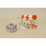 Staffordshire figure group of a red & white cow & calf on naturalistic oval base,