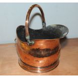 Victorian copper coal bucket of circular helmet form with swing handle & smaller fixed brass handle,