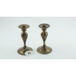 Pair of silver dwarf candlesticks of lobed baluster form, Birmingham, 1911, 5¼", loaded.