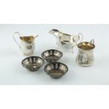 Silver small cream jug, Chester, 1908; a sauce boat; an embossed mug, 1895 & three dishes, 9 oz.