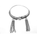 Eastern white metal necklace of torque form with central circular clasp,