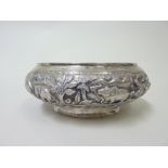 Burmese silver circular bowl with continuous embossed band depicting figures & animals working in a