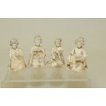 Four small Japanese Meiji period carved figures of seated geisha, two with musical instruments,