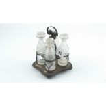 Old Sheffield plated cruet with four diamond & slice cut bottles on square base, c.1815.
