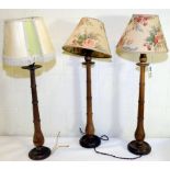 Set of three turned beech table lamps with triple ringed tapered baluster columns on circular foot,