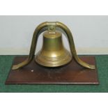 Large brass ship's bell on brass tubular bracket supports & rectangular mahogany plinth base,