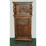 Reproduction oak court cupboard of narrow proportions, the upper section with central door,