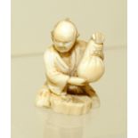 Japanese Meiji period small carved ivory figure of a man holding a sack, unsigned, 1½" high.