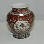 Large Chinese porcelain baluster jar with vermillion ground, four panels of flowers,