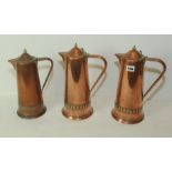 Set of three Art Nouveau copper jugs of tapered form with single scroll handles,