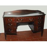 Edwardian mahogany bow front ledge back dressing table, the central drawer above kneehole,