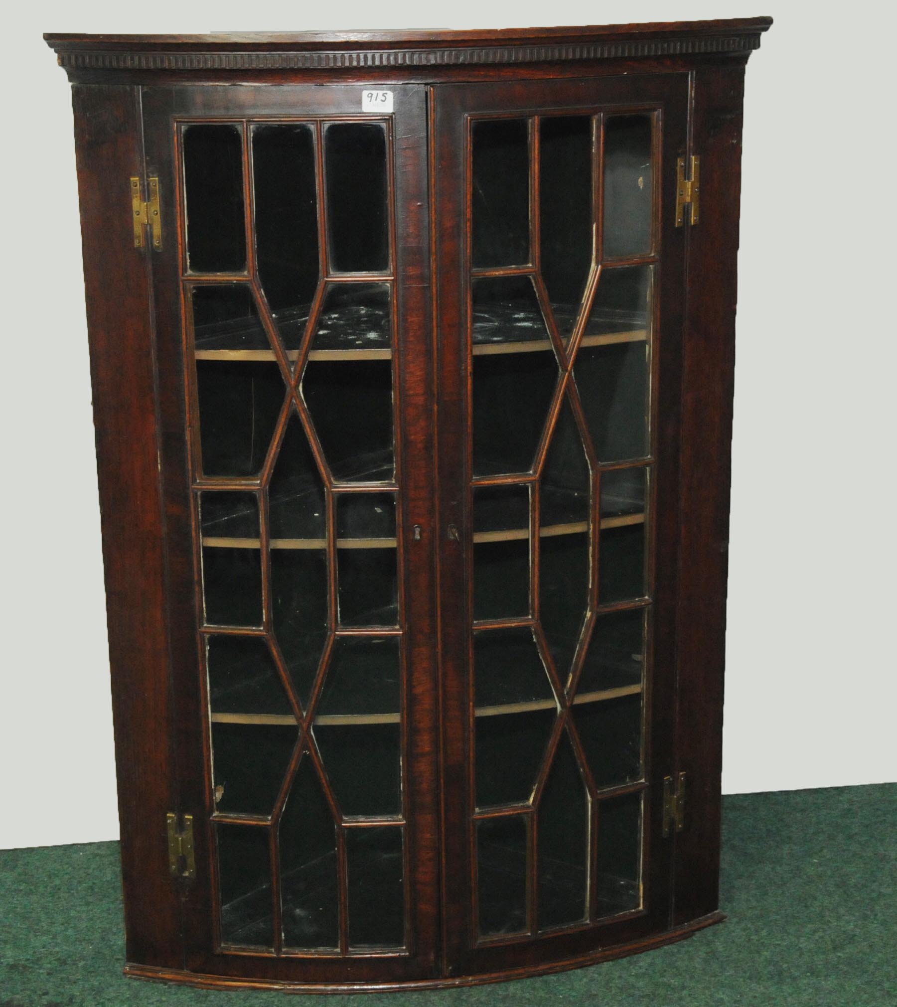 19th century mahogany bow front hanging corner cabinet with moulded pediment above glazed astragal
