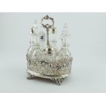 Silver cruet with three mounted & four plain cut glass bottles upon an oval base with pierced sides,