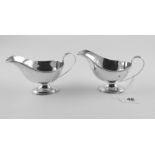 Pair of silver small sauce boats with reeded edges & loop handles on oval bases, by Mappin & Webb,