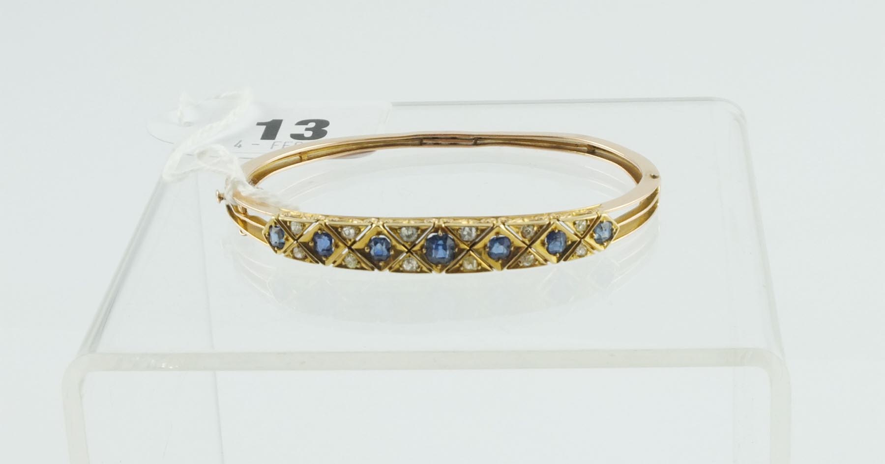 Victorian gold bangle with seven sapphires & diamonds in engraved gold mount.