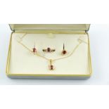 Diamond & ruby suite comprising a pendant with necklet; a ring & a pair of ear studs,