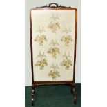 Large glazed mahogany firescreen with foliate scroll pediment above embroidered panel of hanging