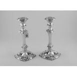 Pair of silver table candlesticks with fluted foliate stems of square section upon similar