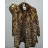 Vintage ocelot fur mid thigh swing coat with trimmed fur collar;