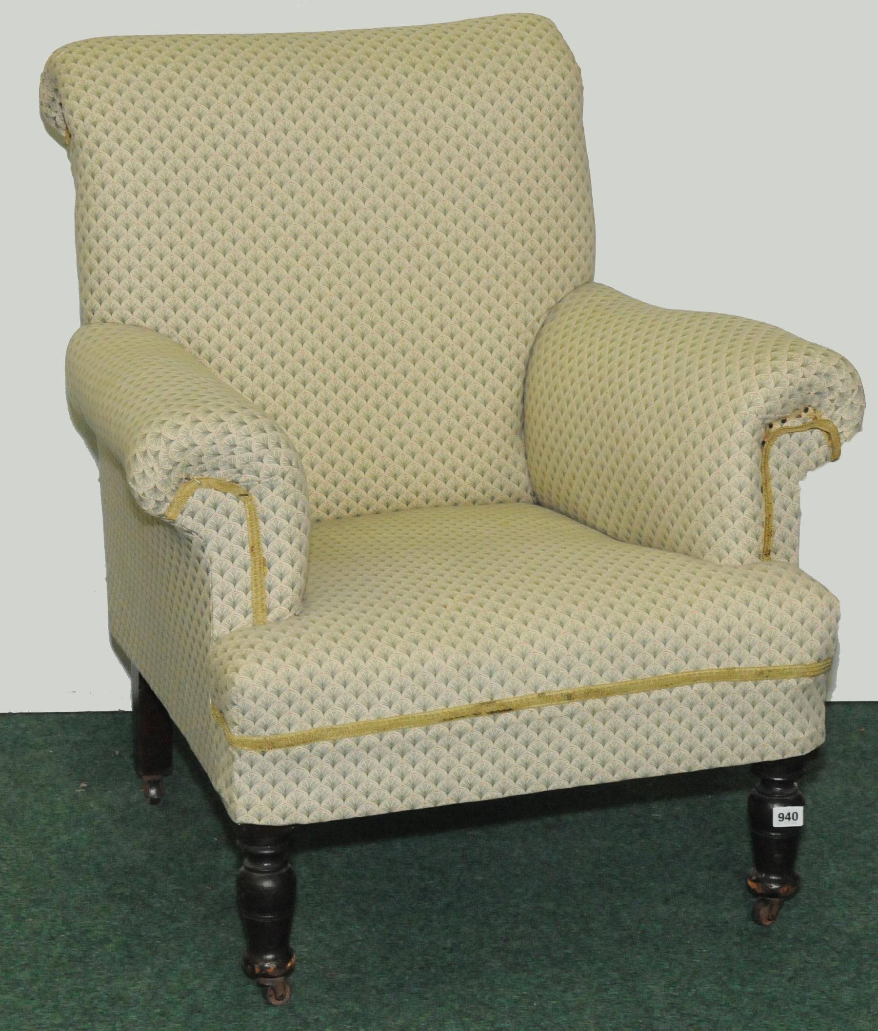 Edwardian upholstered armchair on turned baluster front supports.