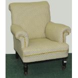Edwardian upholstered armchair on turned baluster front supports.