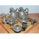 Eight items of antique pewter including: a pair of covered jugs of baluster form;