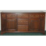 Georgian oak low dresser, the moulded edge rectangular top above five frieze drawers, two