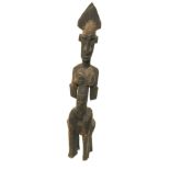 African Dogon, Mali, carved figure of a seated woman with further staining, 20¼" high.