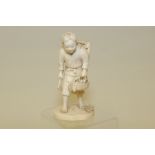 Japanese Meiji period carved ivory okimono of a farm boy carrying a basket of fruit, signed, 6"