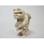 Japanese Meiji period carved ivory netsuke of a small boy dressed in a dragon costume, unsigned, 3¼"