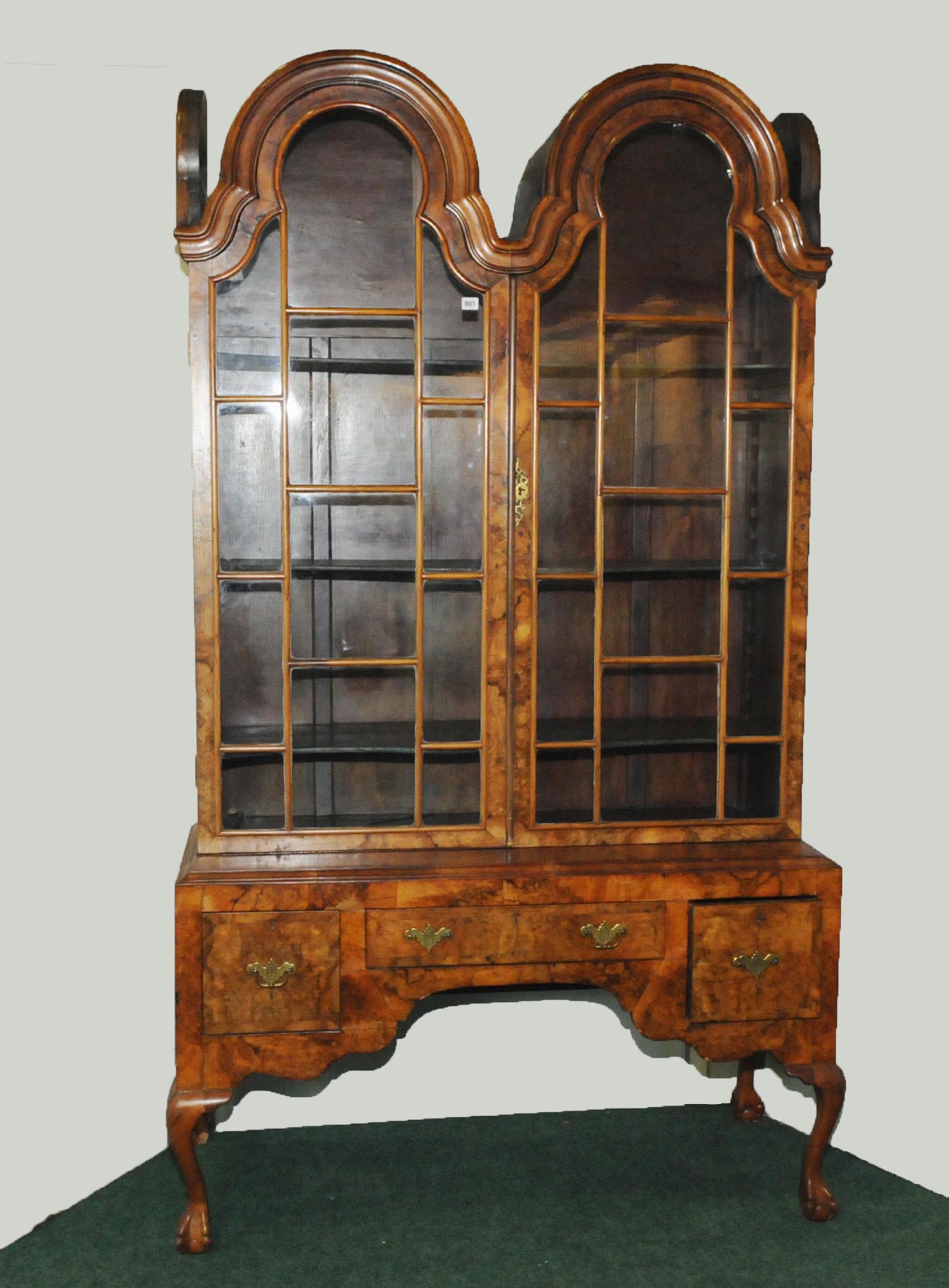 Late 19th century walnut cabinet in the Dutch style with lobed double scroll top above glazed