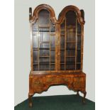 Late 19th century walnut cabinet in the Dutch style with lobed double scroll top above glazed