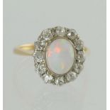 Opal & diamond oval cluster ring with twelve old cut brilliants, '18ct', size N.
