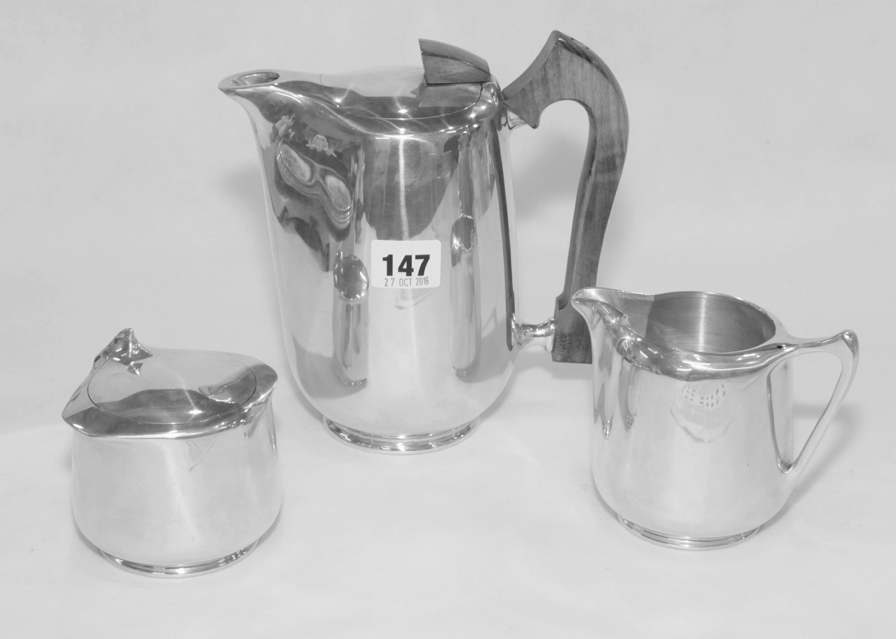 Three pieces of Piquot Ware, comprising: hot water jug; covered sugar bowl & milk jug.