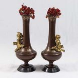 Pair of Patinated Bronze Vases with Cupid Relief